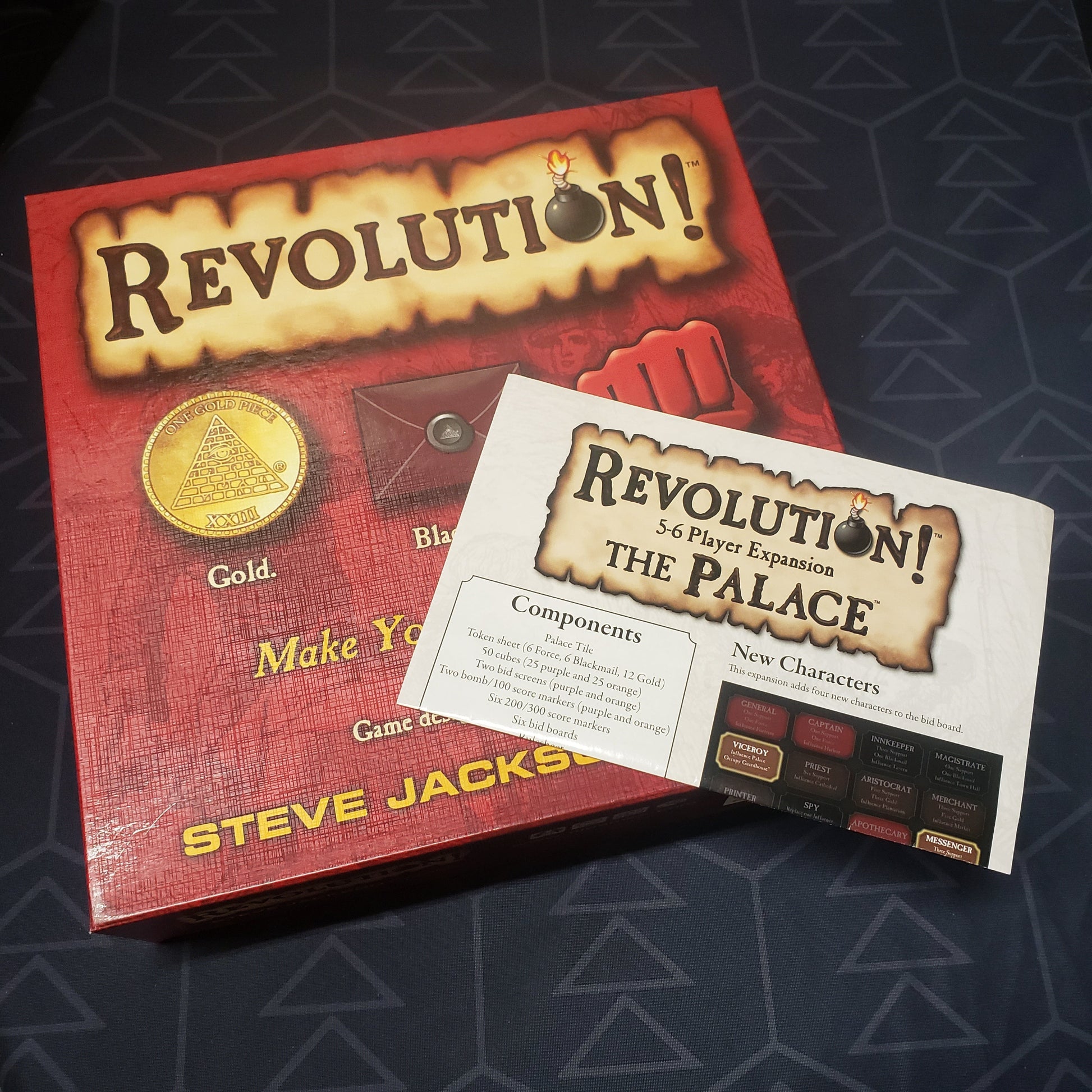 Image shows the front cover of the box of the Revolution board game, along with the instructions for "The Palace" 5-6 Player expansion sitting on top of it