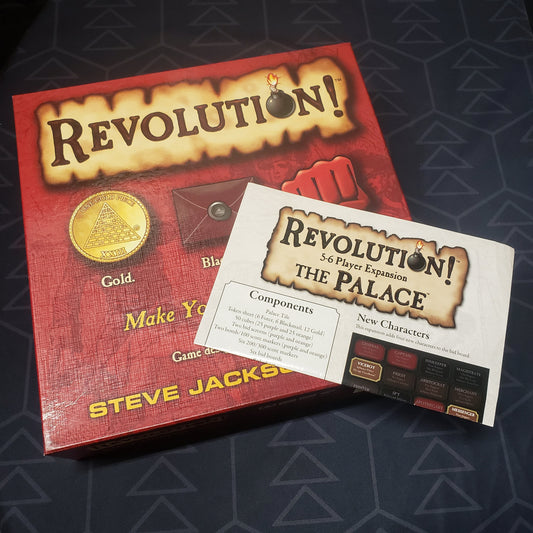 Image shows the front cover of the box of the Revolution board game, along with the instructions for "The Palace" 5-6 Player expansion sitting on top of it