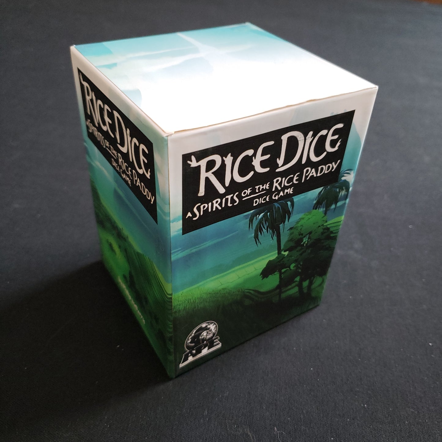 Image shows the front cover of the box of the Rice Dice board game