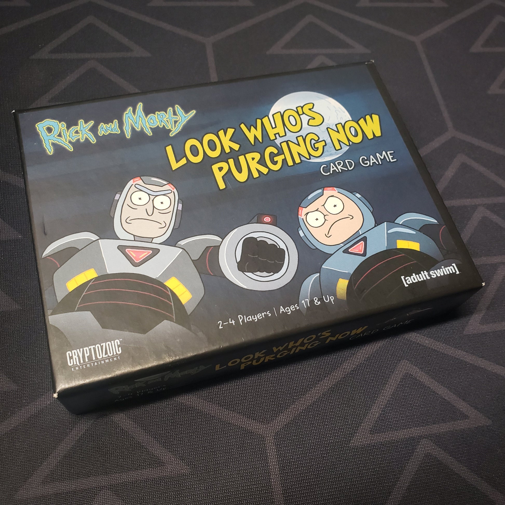 Image shows the front cover of the box for the Rick & Morty: Look Who's Purging Now card game