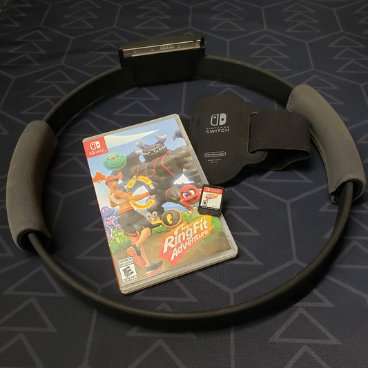 Image shows the case, cartridge and workout accessories for the video game Ring Fit Adventure for Nintendo Switch