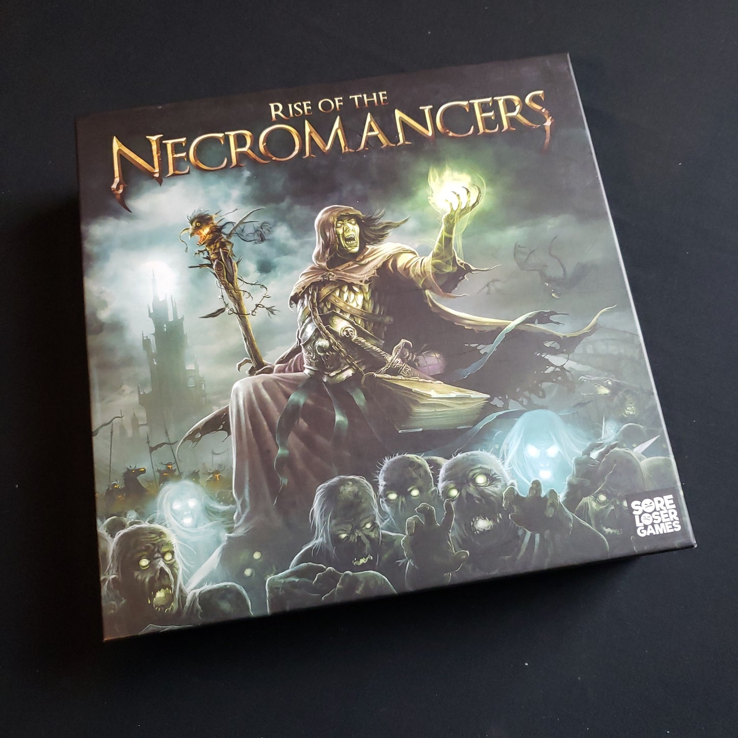 Image shows the front cover of the box of the Rise of the Necromancers board game