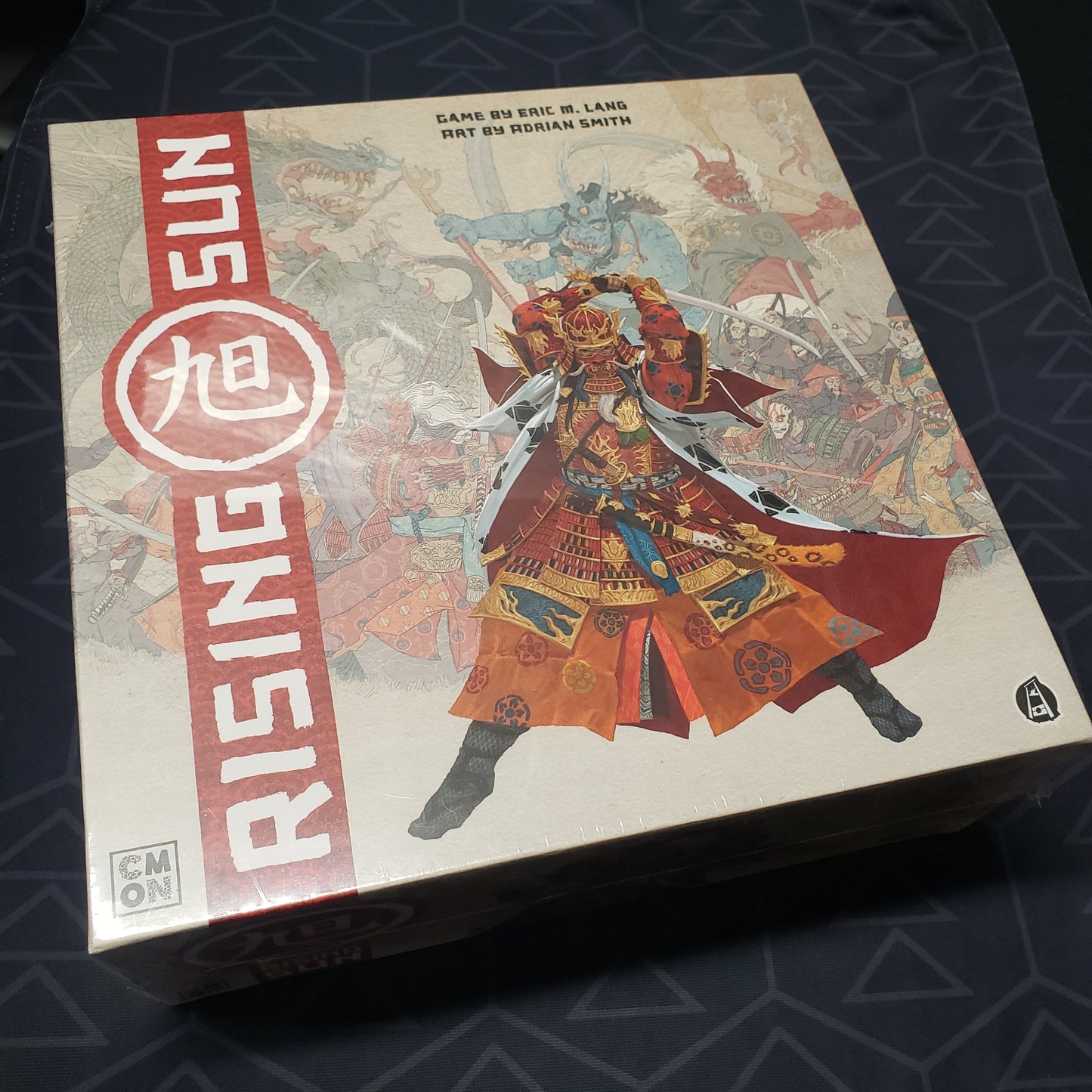 Image shows the front cover of the box for the Rising Sun board game