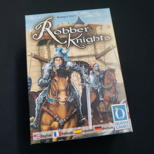 Image shows the front cover of the box of the Robber Knights board game