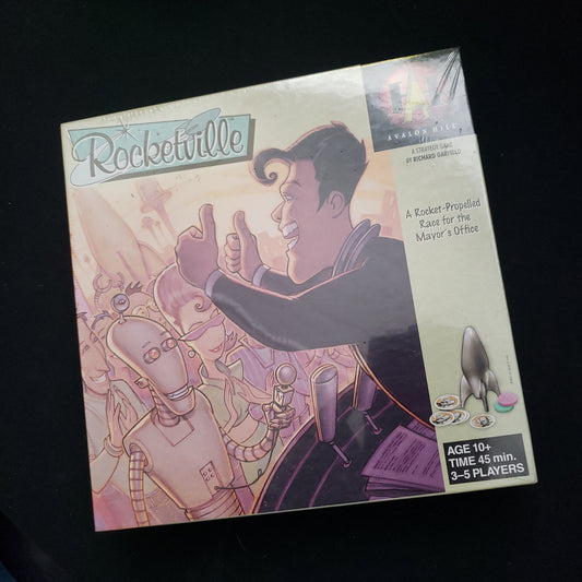 Image shows the front cover of the box of the Rocketville board game