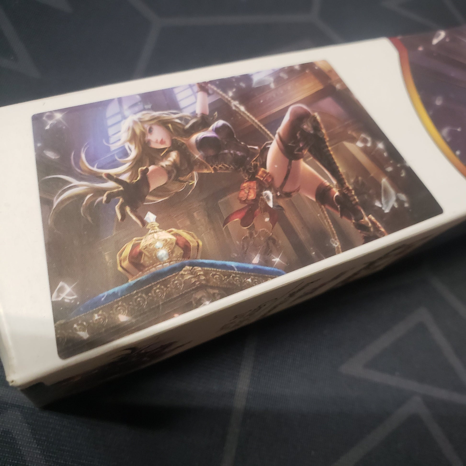 Image shows close-up of the art on the side of the box for the Rogue's Reward card game playmat