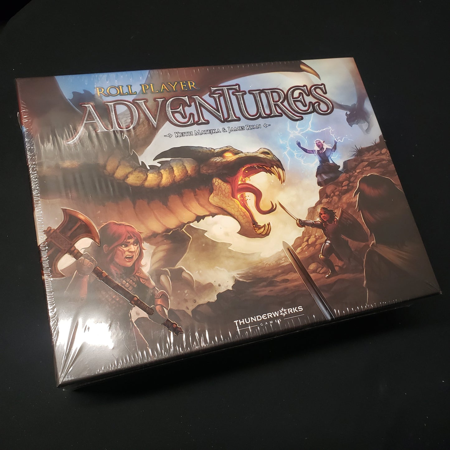Image shows the front cover of the box for the Roll Player Adventures board game