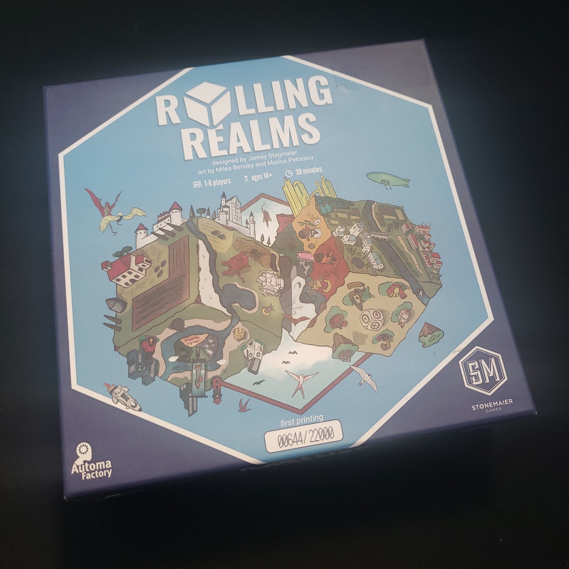 Image shows the front cover of the box of the Rolling Realms board game