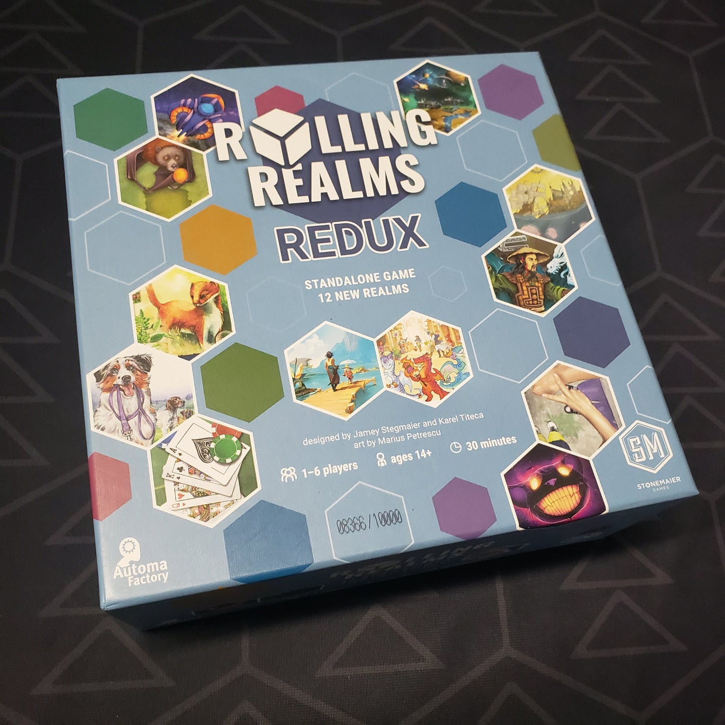 Image shows the front cover of the box for the Rolling Realms Redux board game