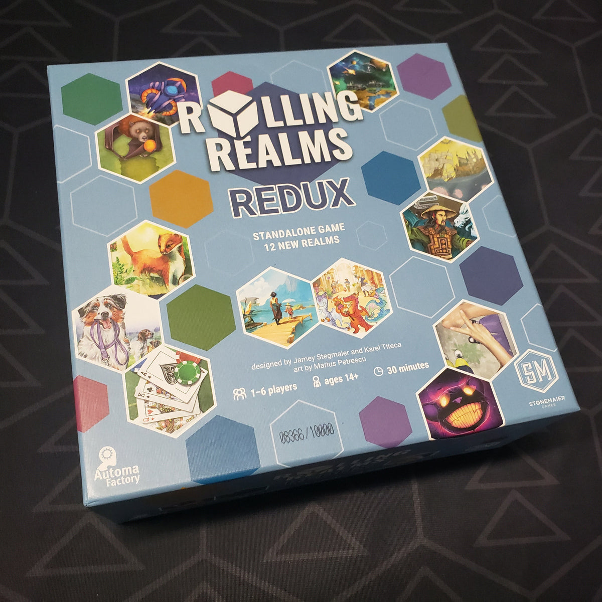 Image shows the front cover of the box for the Rolling Realms Redux board game