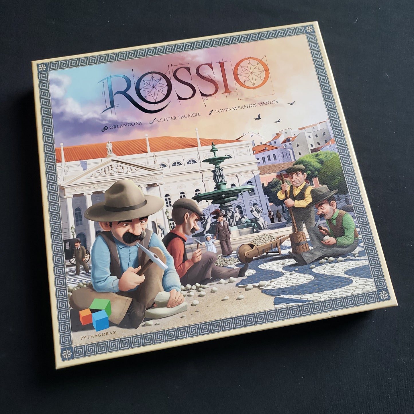 Image shows the front cover of the box of the Rossio board game