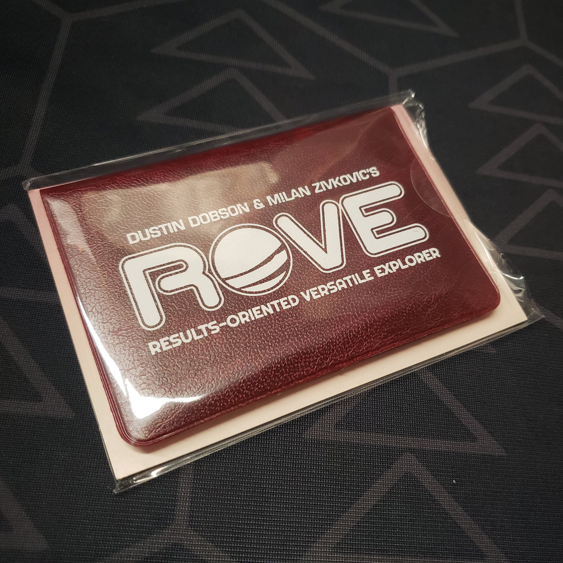 Image shows the front of the card wallet for the ROVE: Results-Oriented Versatile Explorer card game
