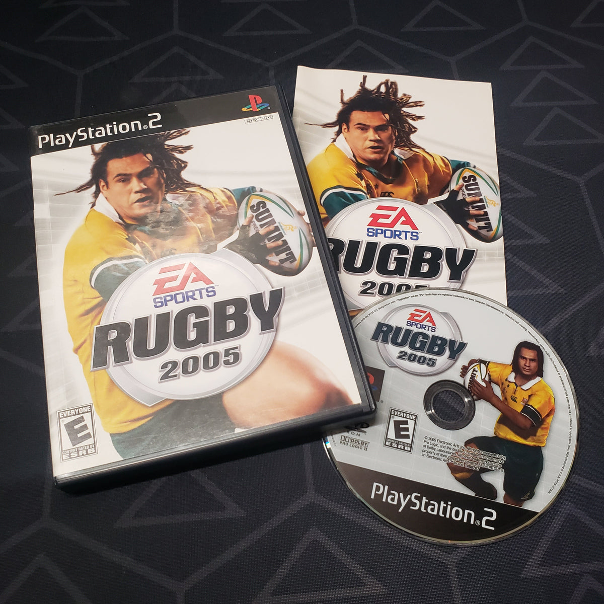 Image shows the case, manual and disc for the video game Rugby 2005 for Playstation 2