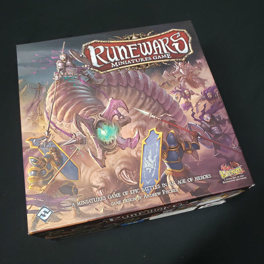 Image shows the front cover of the box of the Runewars: Miniatures Game