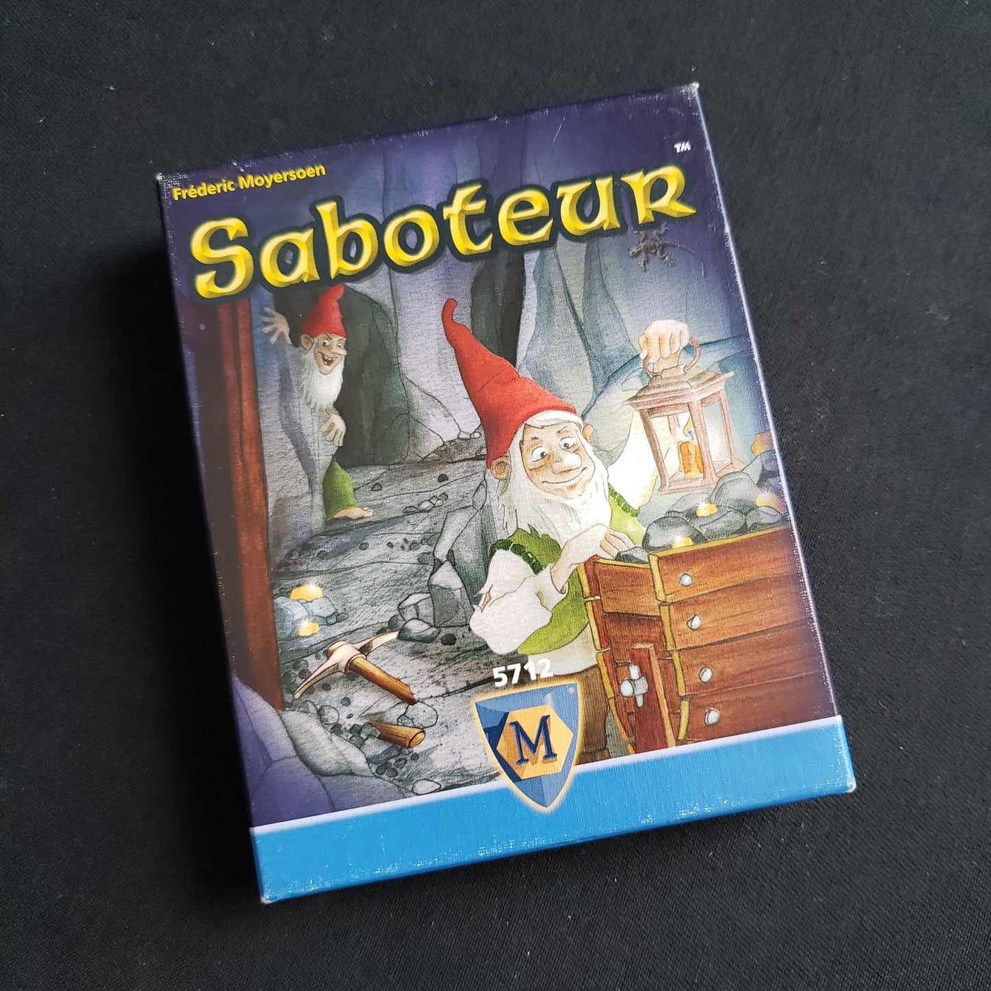 Image shows the front cover of the box of the Saboteur card game