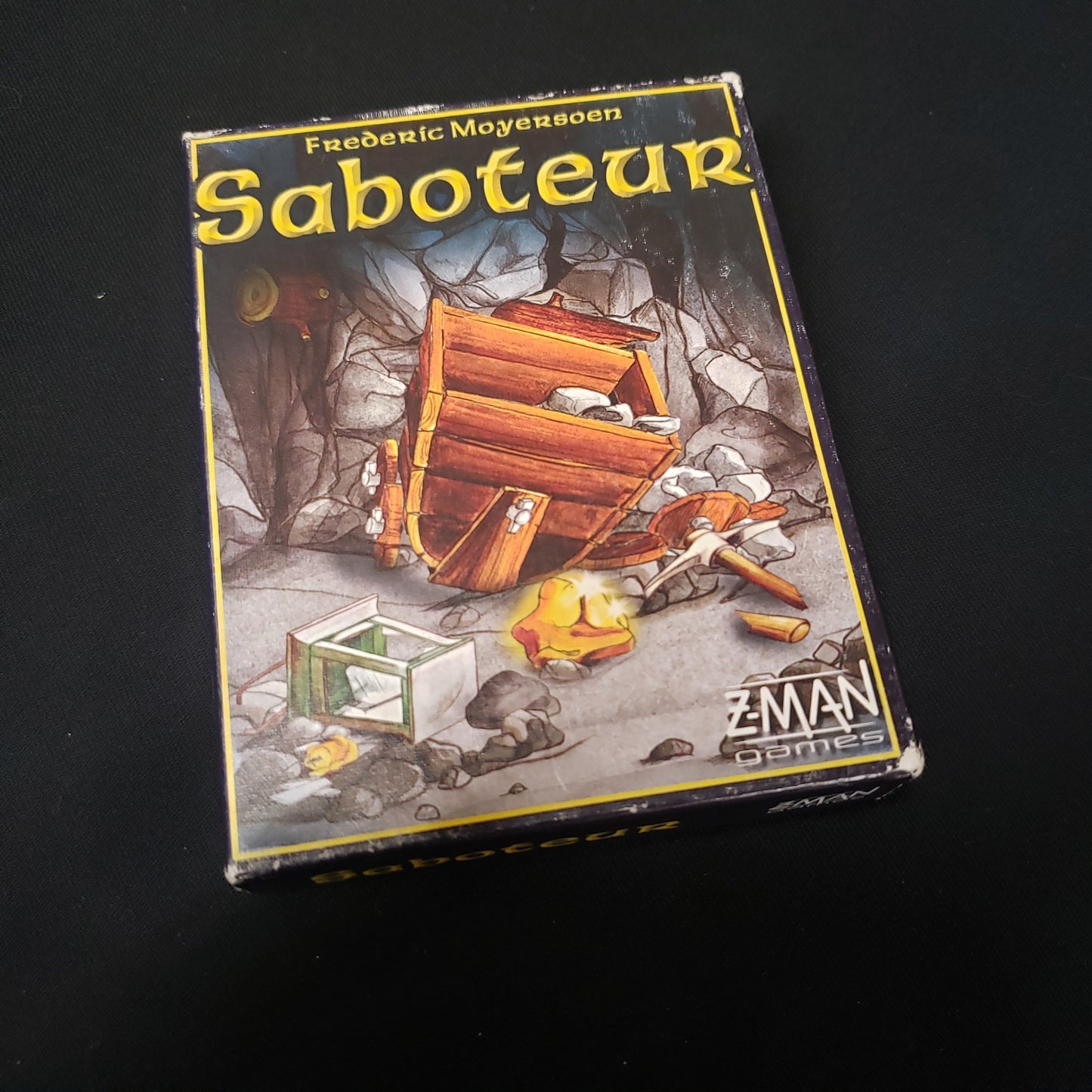 Image shows the front cover of the box of the Saboteur card game