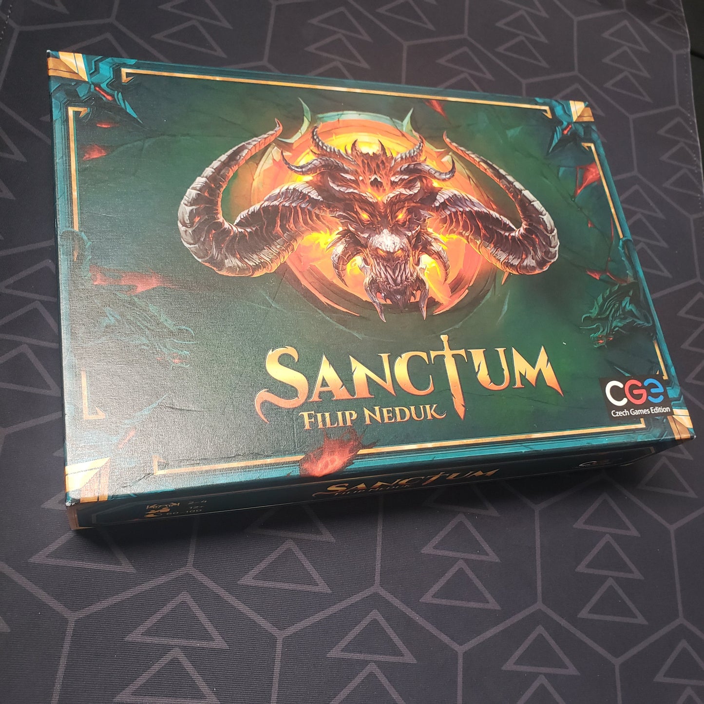 Image shows the front cover of the box for the Sanctum board game