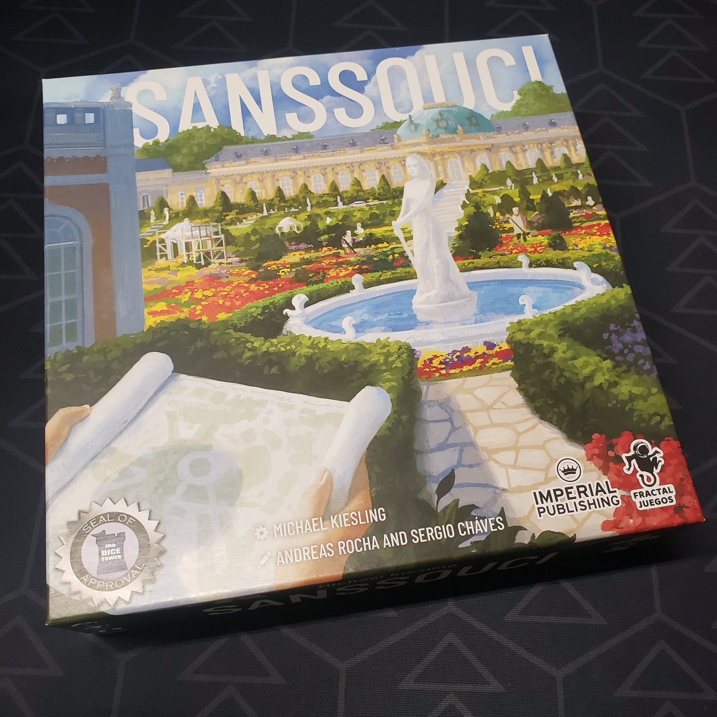 Image shows the front cover of the box for the Sanssouci board game