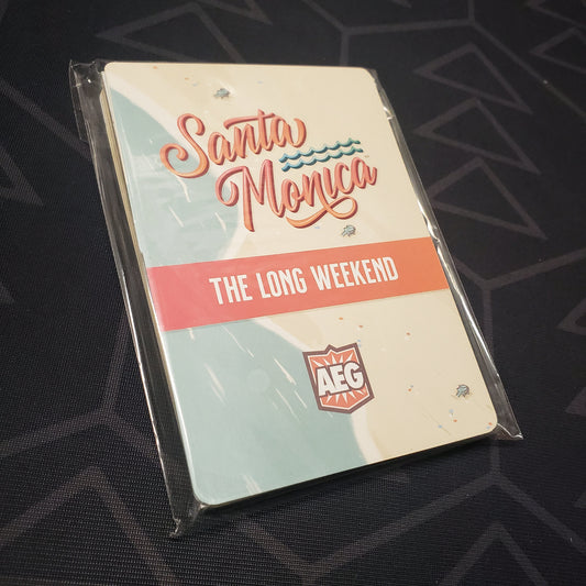 Image shows the front of the packaging for the Long Weekend expansion for the board game Santa Monica