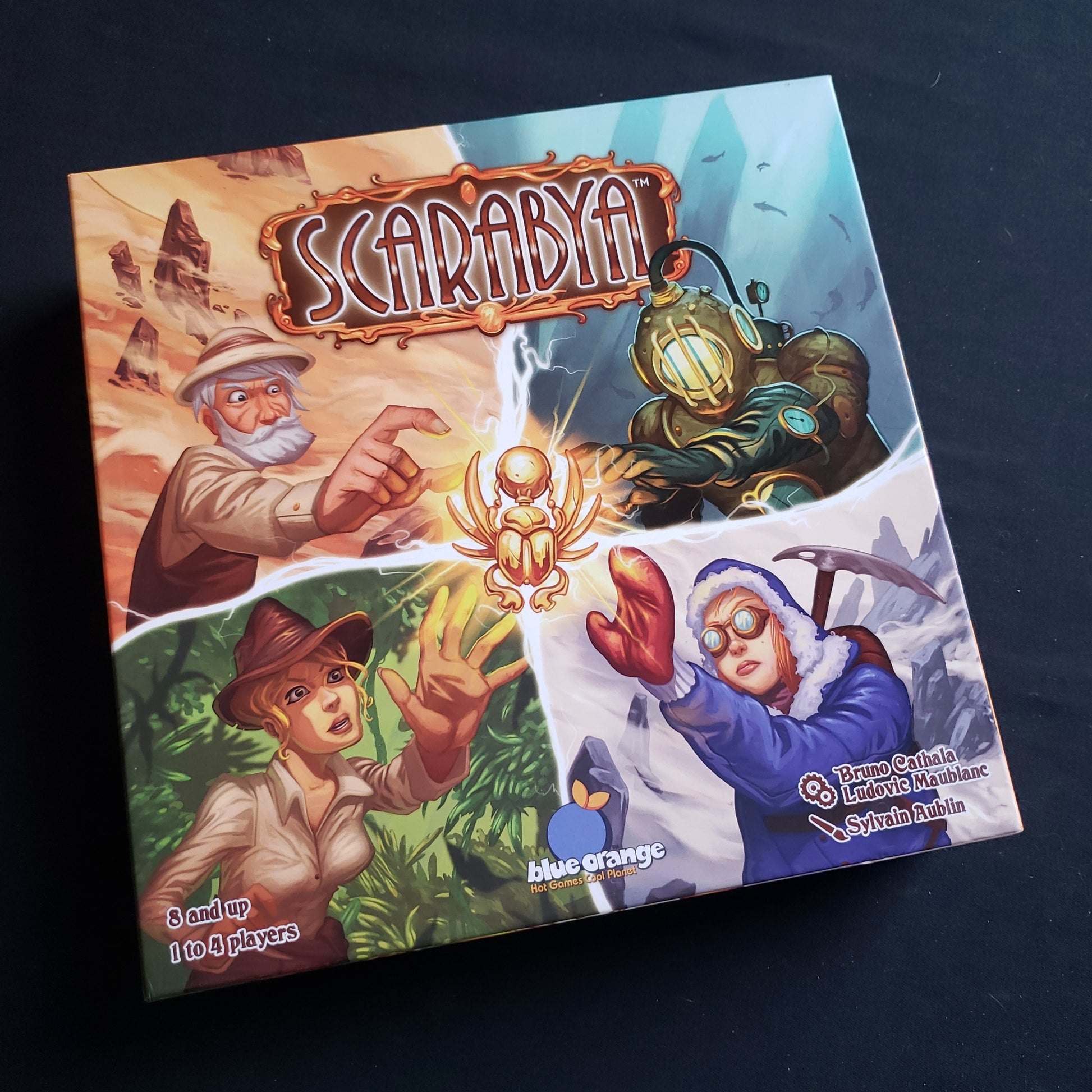 Image shows the front cover of the box of the Scarabya board game