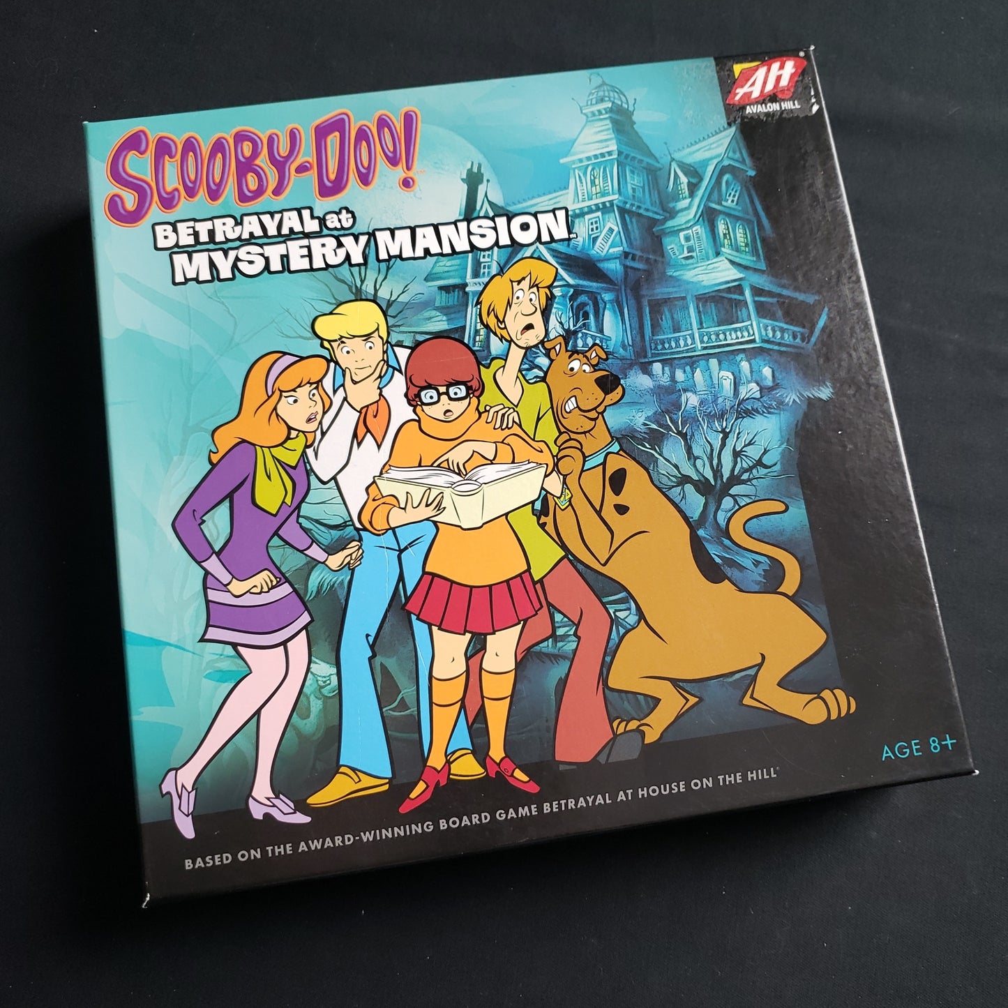Image shows the front cover of the box of the Scooby Doo: Betrayal at Mystery Mansion board game