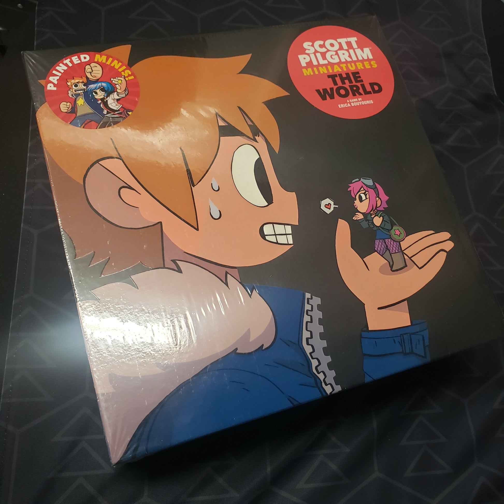 Image shows the front cover of the box of the Expansion Box for the board game Scott Pilgrim Miniatures the World