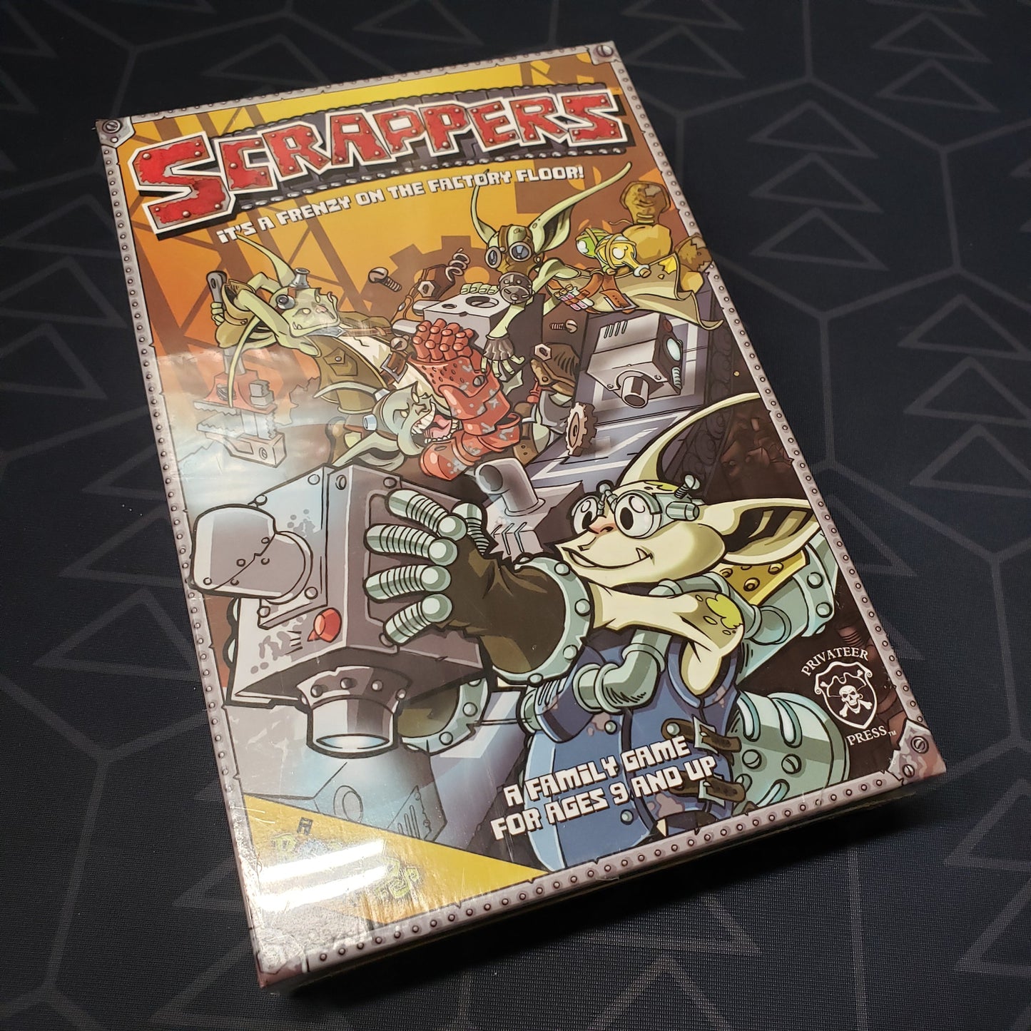 Image shows the front cover of the box for the Scrappers board game