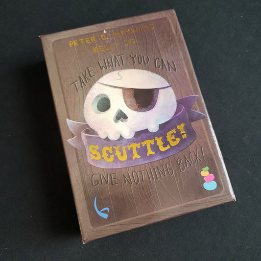 Image shows the front cover of the box of the Scuttle card game