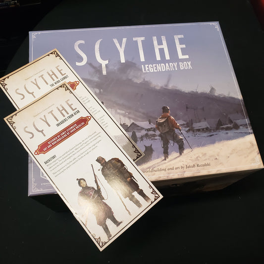 Image shows the front cover of the Legendary Box storage solution for the board game Scythe, with instructions for two expansions sitting on top of it