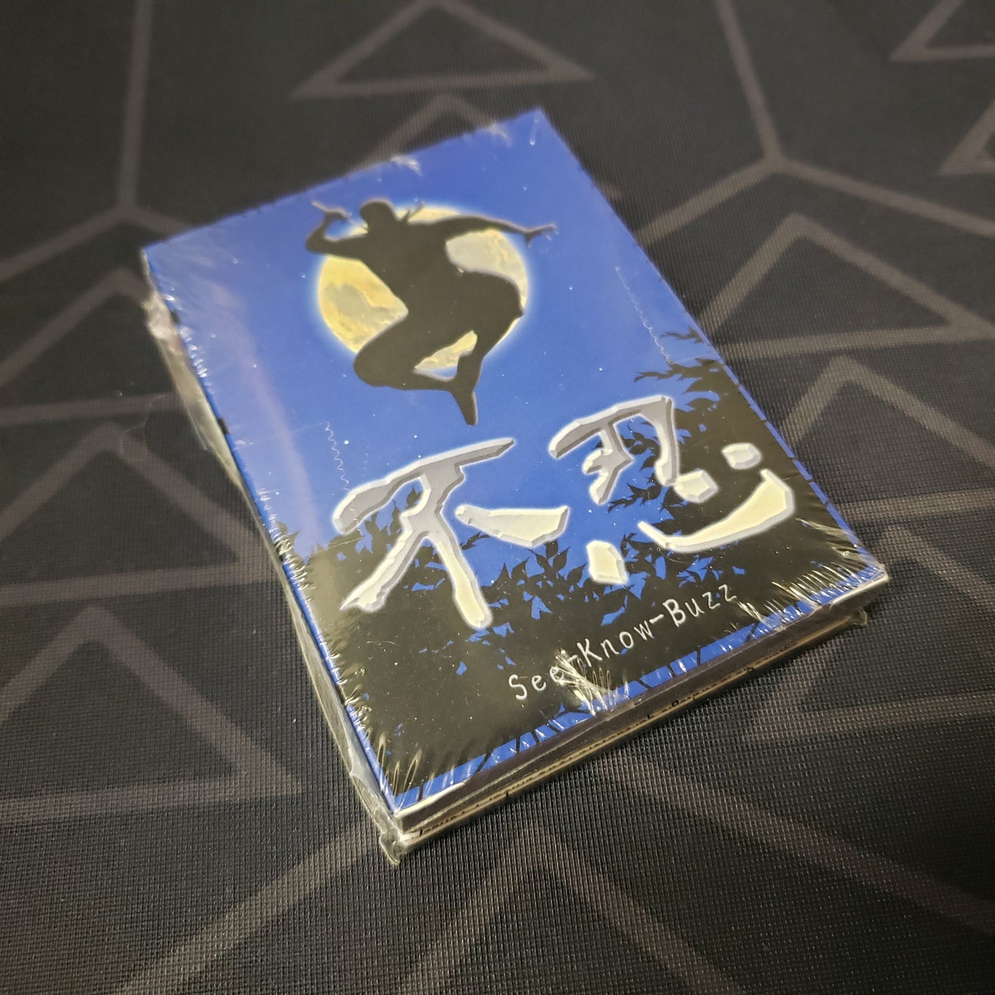 Image shows the front cover of the box for the See-Know-Buzz card game