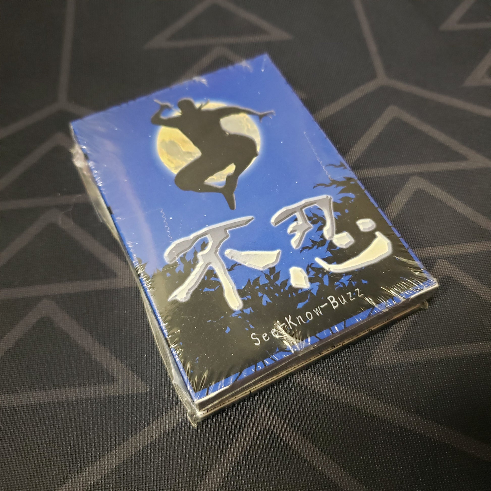 Image shows the front cover of the box for the See-Know-Buzz card game
