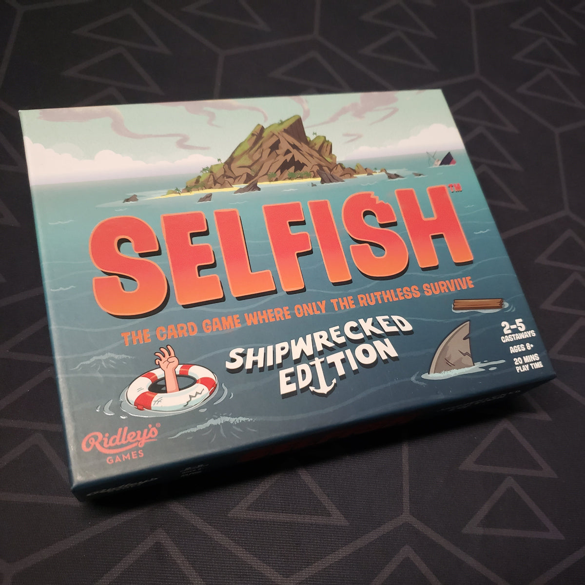 Image shows the front cover of the box for the Selfish: Shipwrecked Edition card game