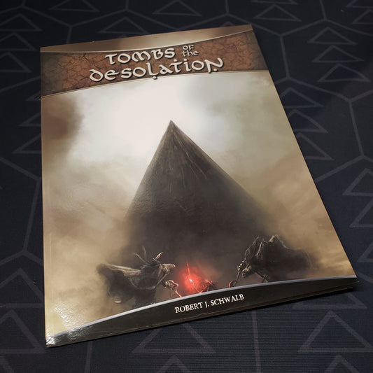 Image shows the front cover of the Tombs of the Desolation book for the roleplaying game Shadow of the Demon Lord