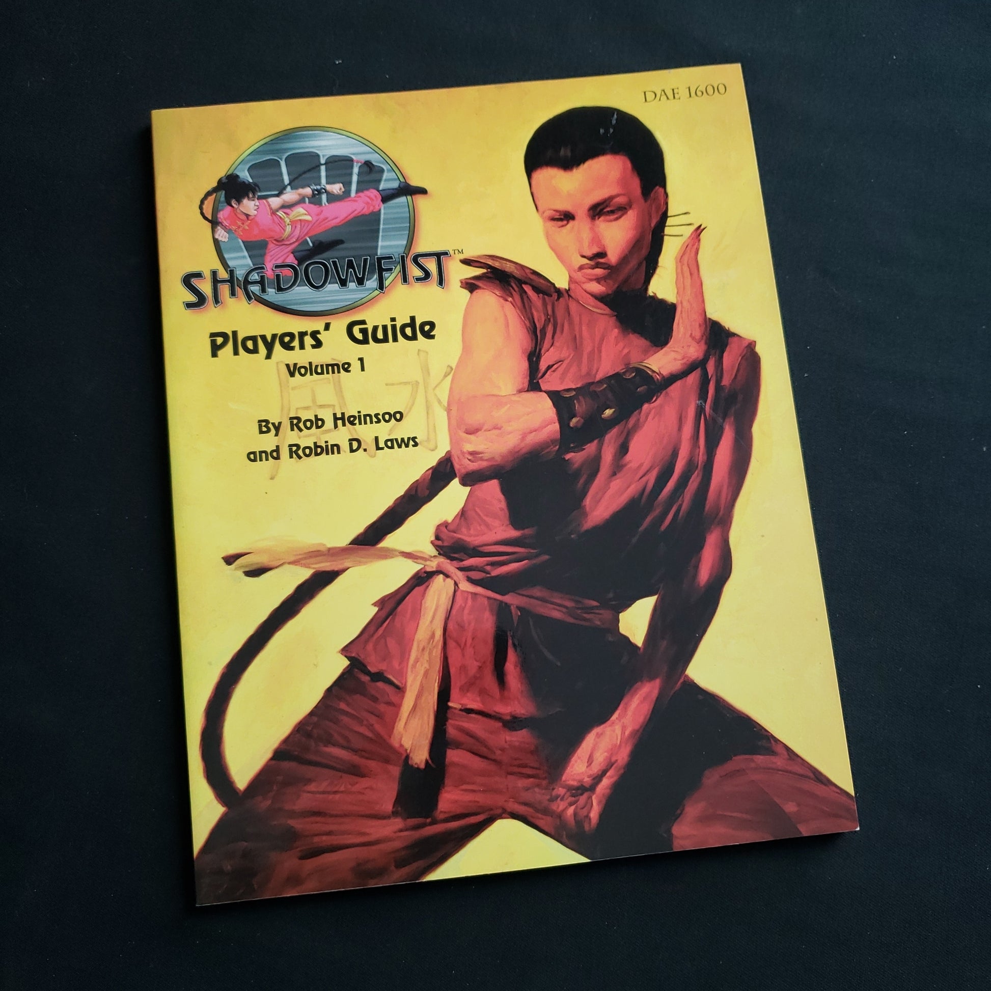 Image shows the front cover of the Players Guide Volume 1 book for the Shadowfist card game
