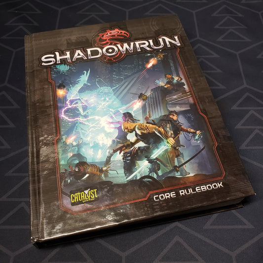 Image shows the front cover of the core rulebook for the roleplaying game Shadowrun: Fifth Edition