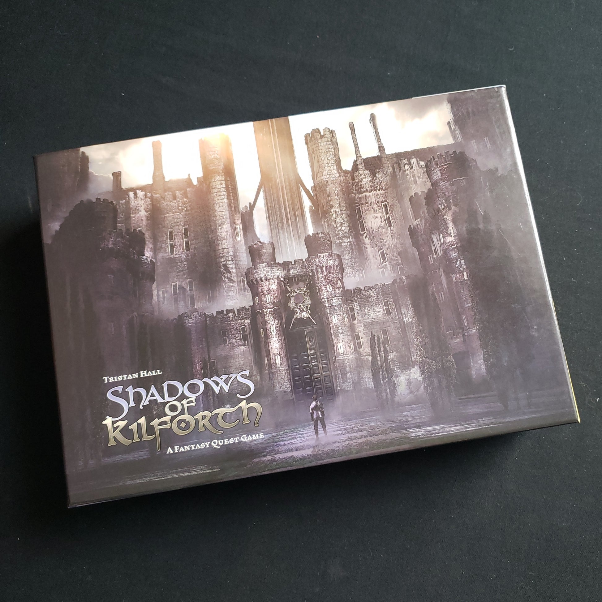 Image shows the front cover of the box of the Shadows of Kilforth card game