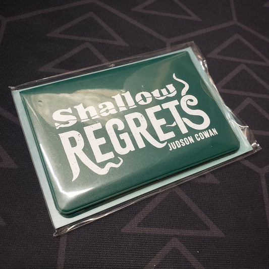 Image shows the front of the card wallet for the Shallow Regrets card game