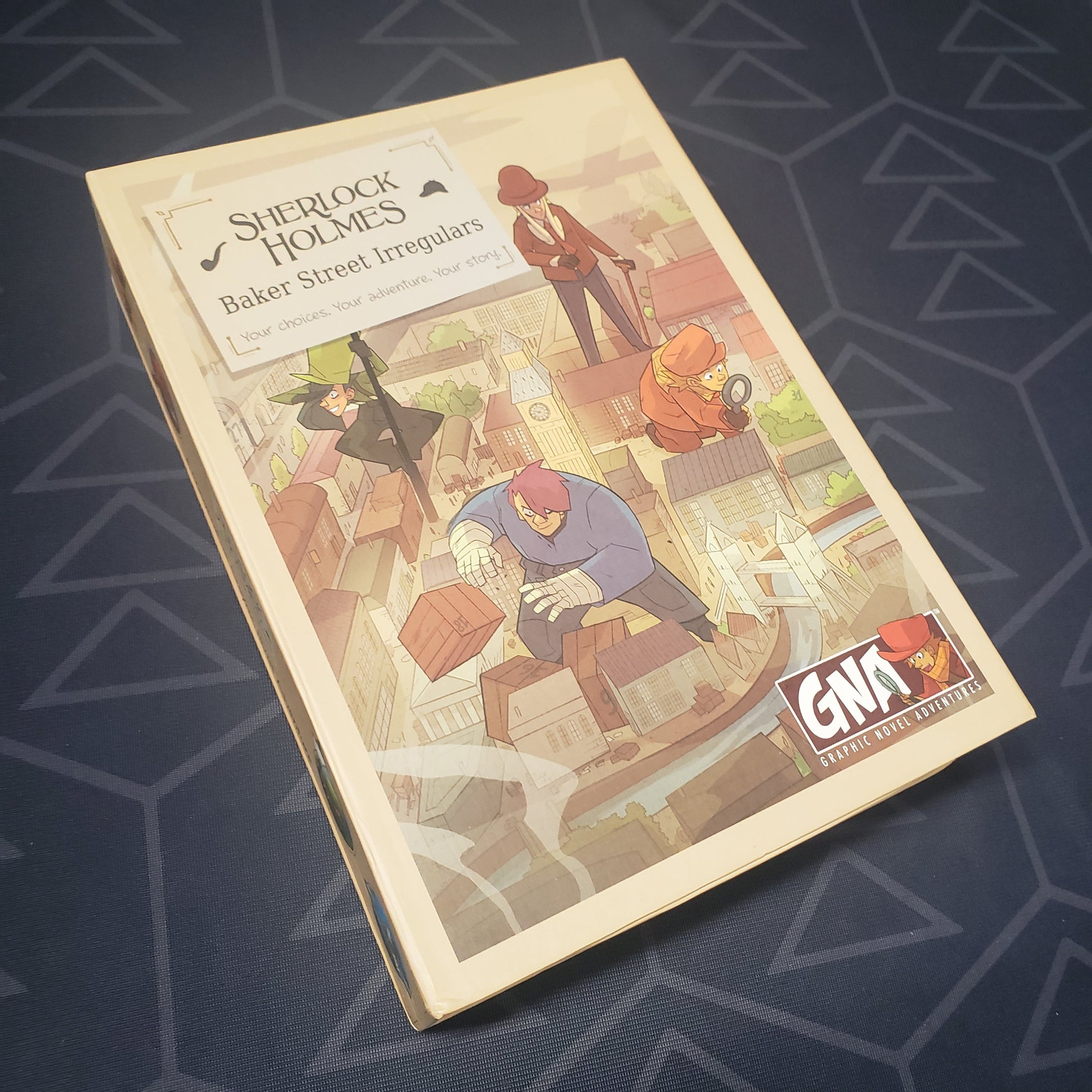Image shows the front cover of the box for the Graphic Novel Adventures game Sherlock Holmes: Baker Street Irregulars