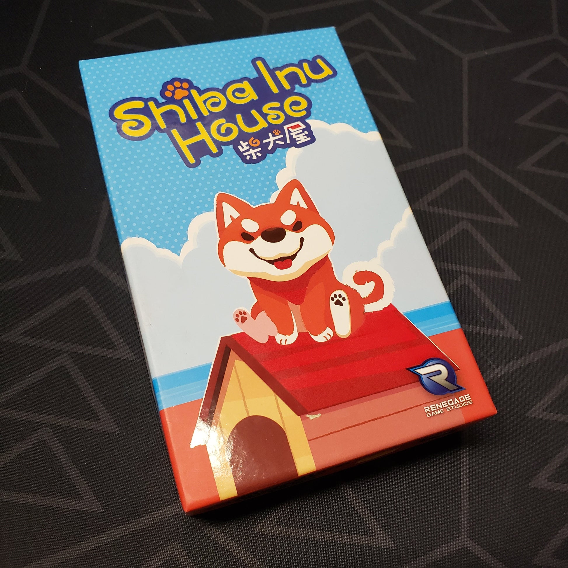 Image shows the front cover of the box for the Shiba Inu House card game