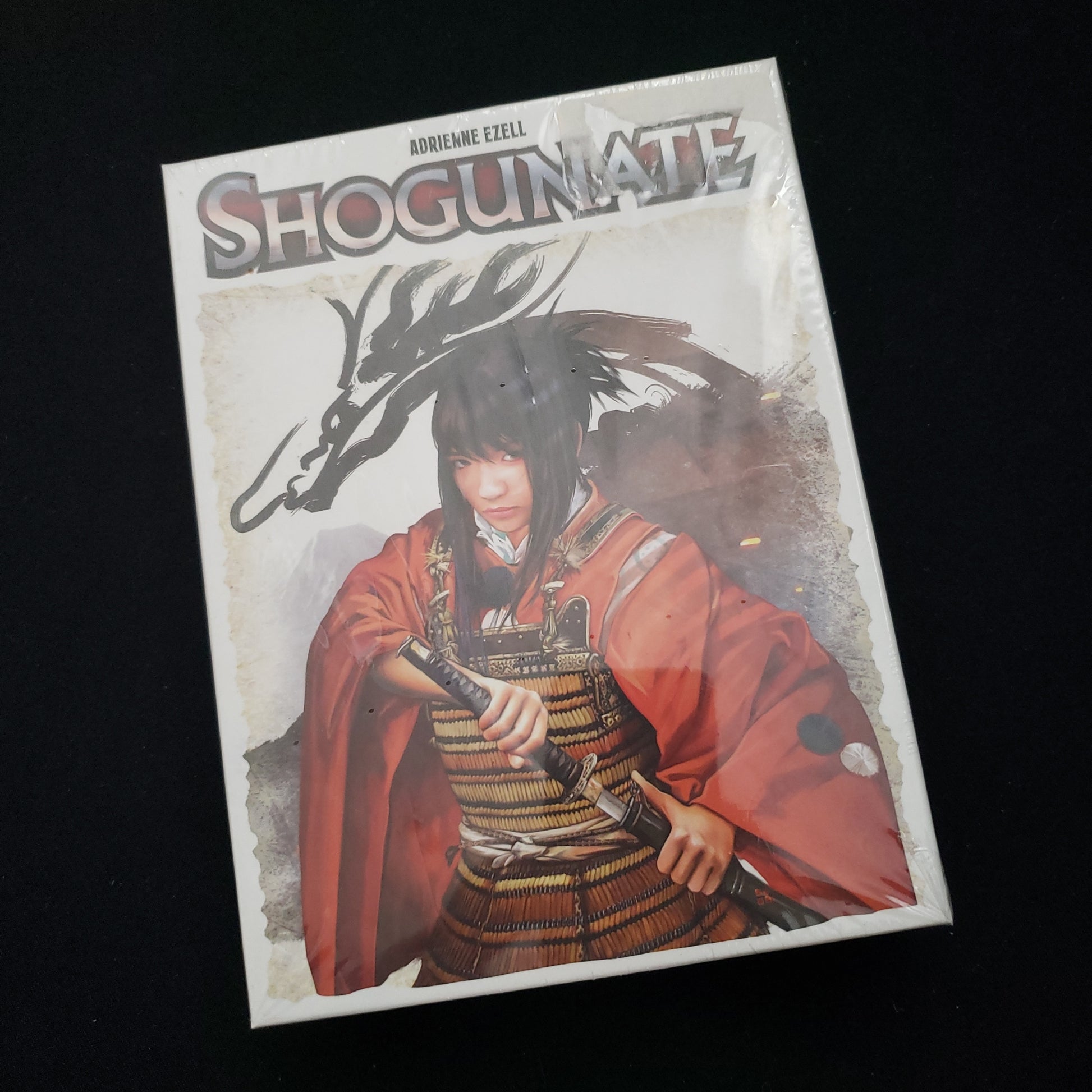 Image shows the front cover of the box of the Shogunate card game