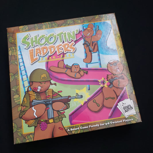 Image shows the front cover of the box of the Shootin' Ladders: Frag Fest board game