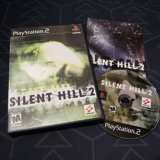 Image shows the case, manual and disc for the video game Silent Hill 2 for Playstation 2