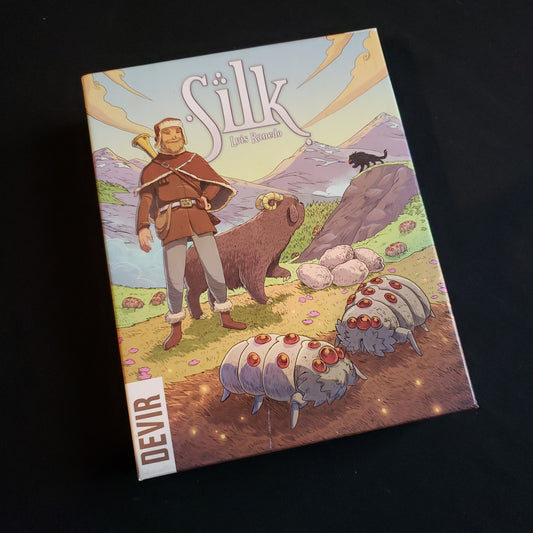 Image shows the front cover of the box of the Silk board game