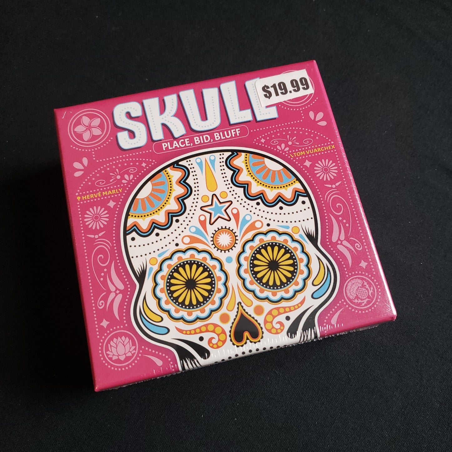 Image shows the front cover of the box of the Skull card game