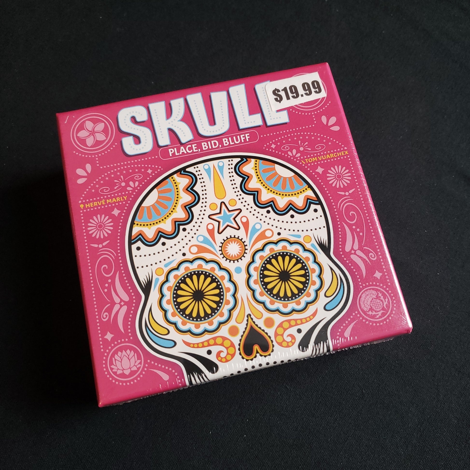 Image shows the front cover of the box of the Skull card game
