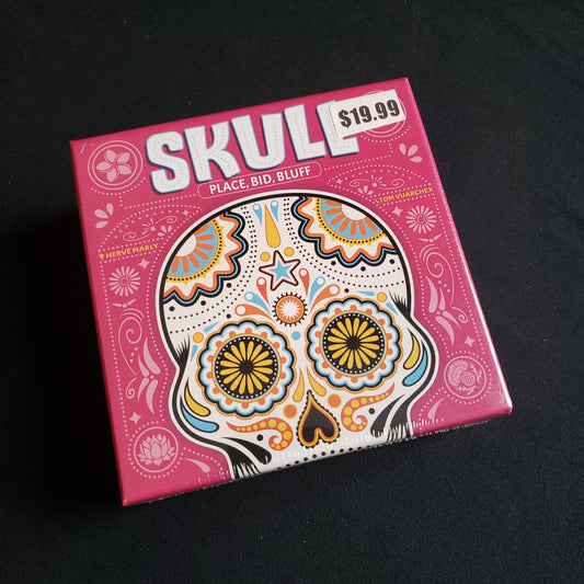 Image shows the front cover of the box of the Skull card game