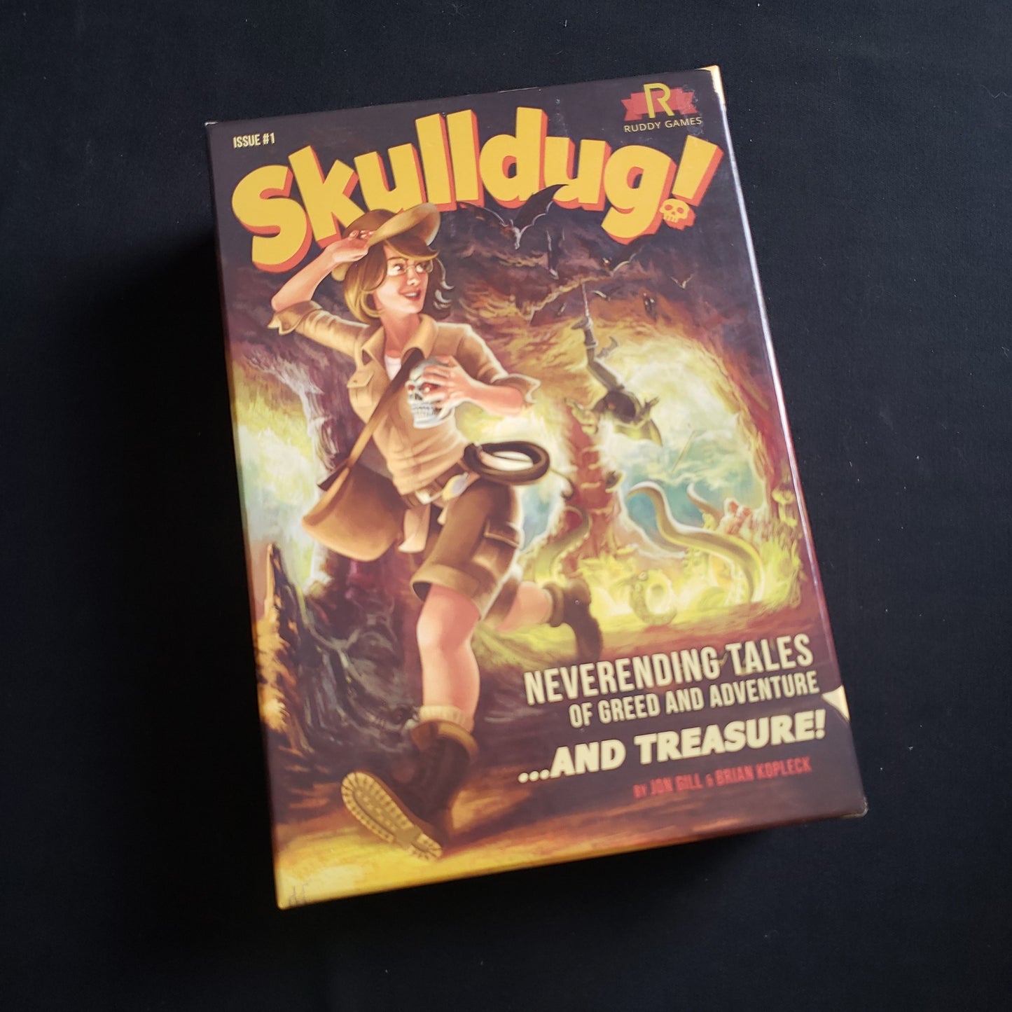 Image shows the front cover of the box of the Skulldug board game