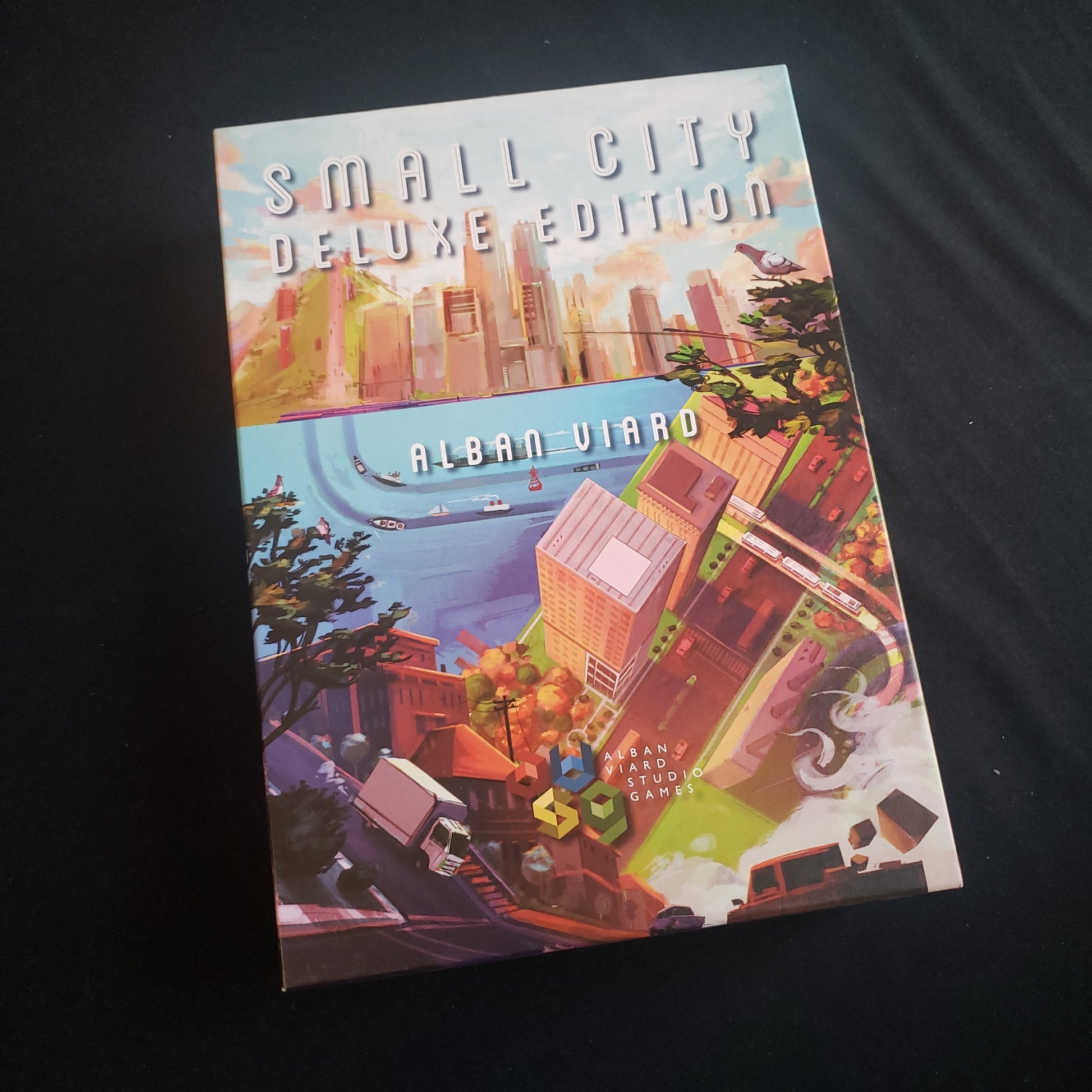 Image shows the front cover of the box of the Small City: Deluxe Edition board game