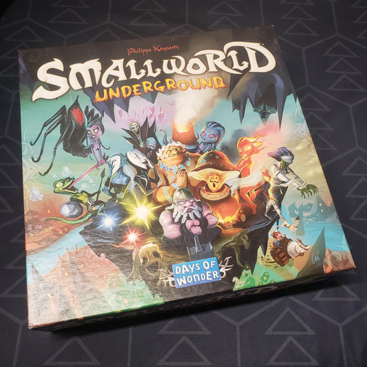 Image shows the front cover of the box of the Small World Underground board game