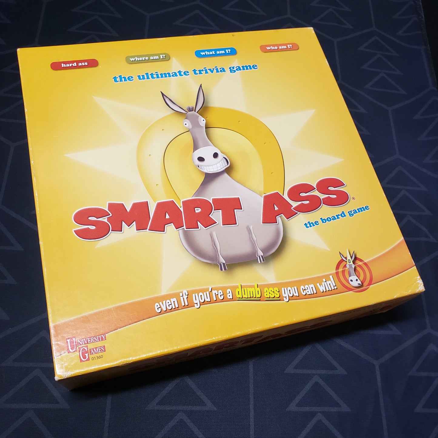 Image shows the front cover of the box for the Smart Ass board game